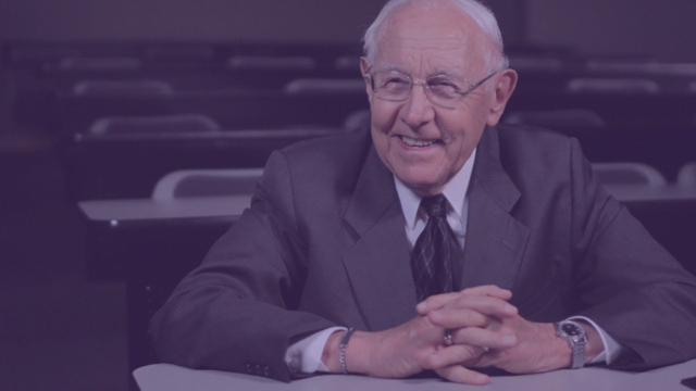 Dr. Toussaint seated in a DTS classroom