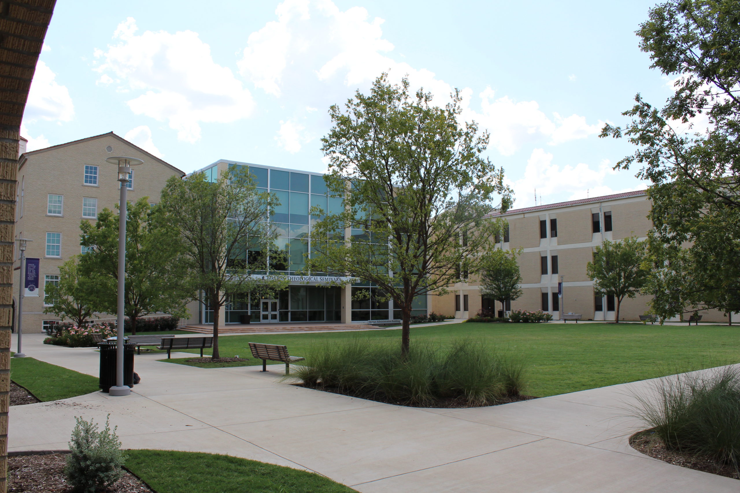 Lawn outside glass-walled entry and steps into Horner Administration Building